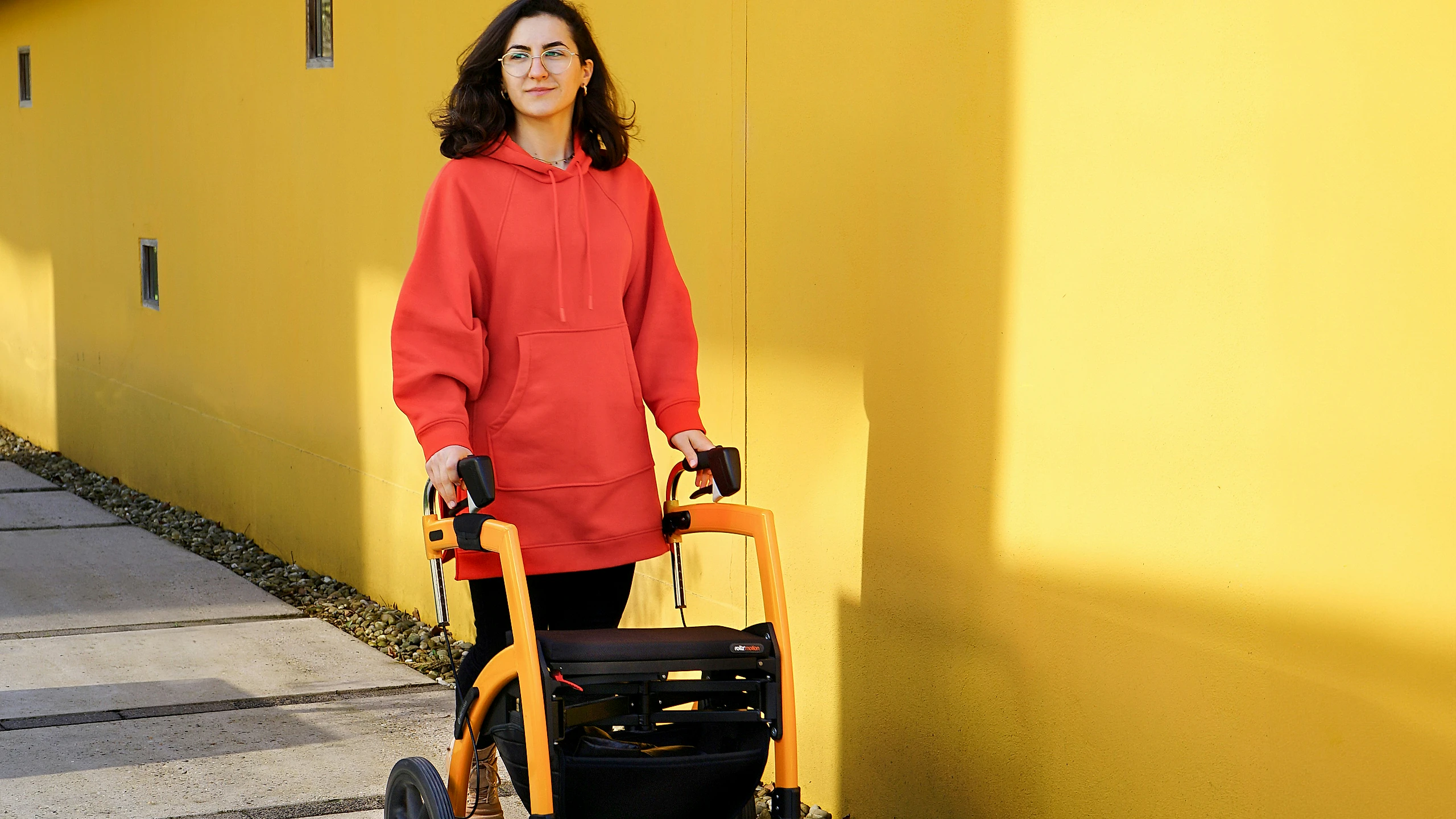 An older adult walking with support